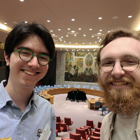 Kane and a colleague taking a selfie in the UN Security Council chamber